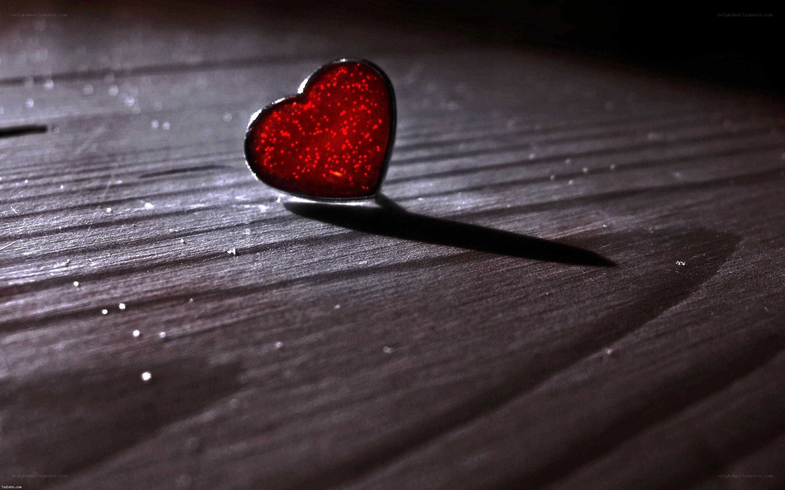 red heart on wooden surface