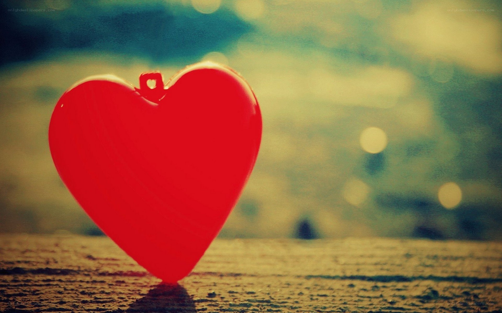 Red heart on wooden surface