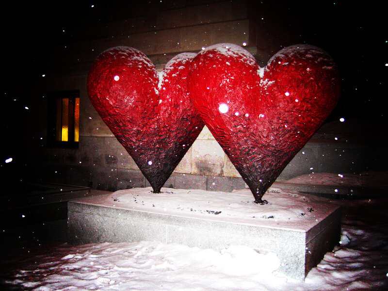 Red heart sculptures in snow