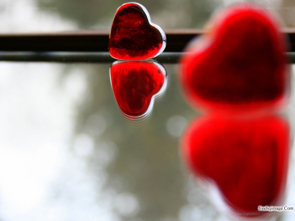 Red hearts on reflective surface