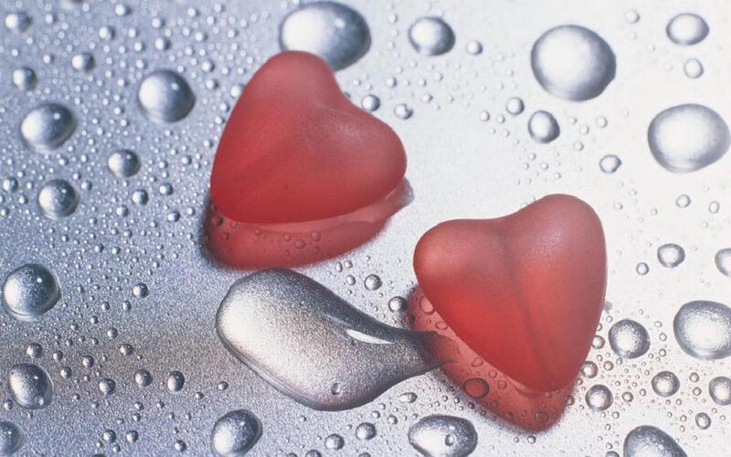 Red hearts on wet surface