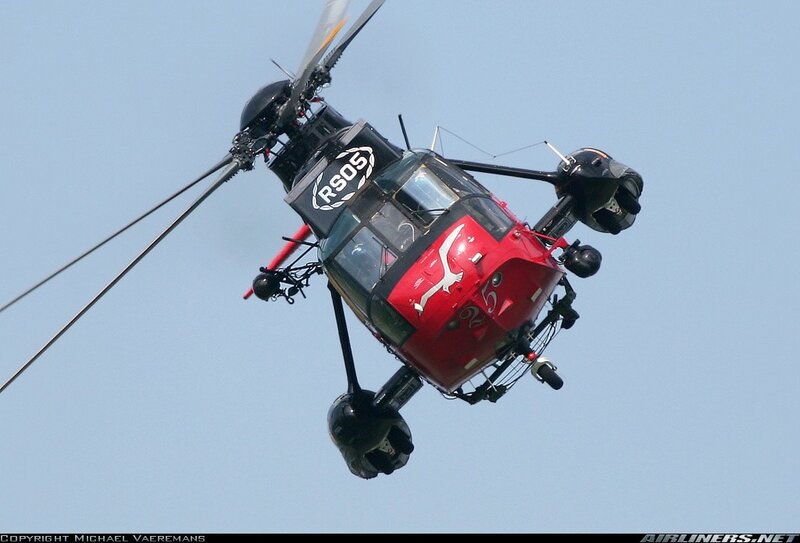 Red helicopter in flight