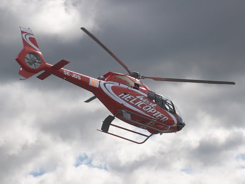 Red Helicopter in Flight — Dramatic, Photograph