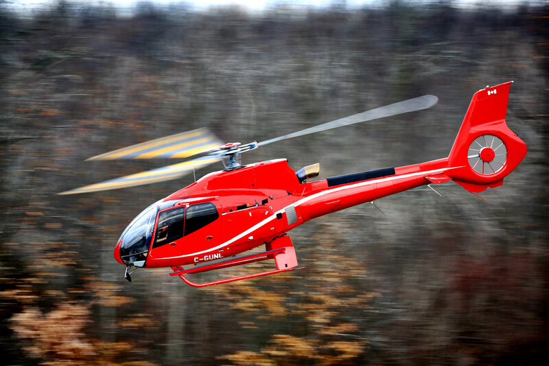 Red helicopter in flight