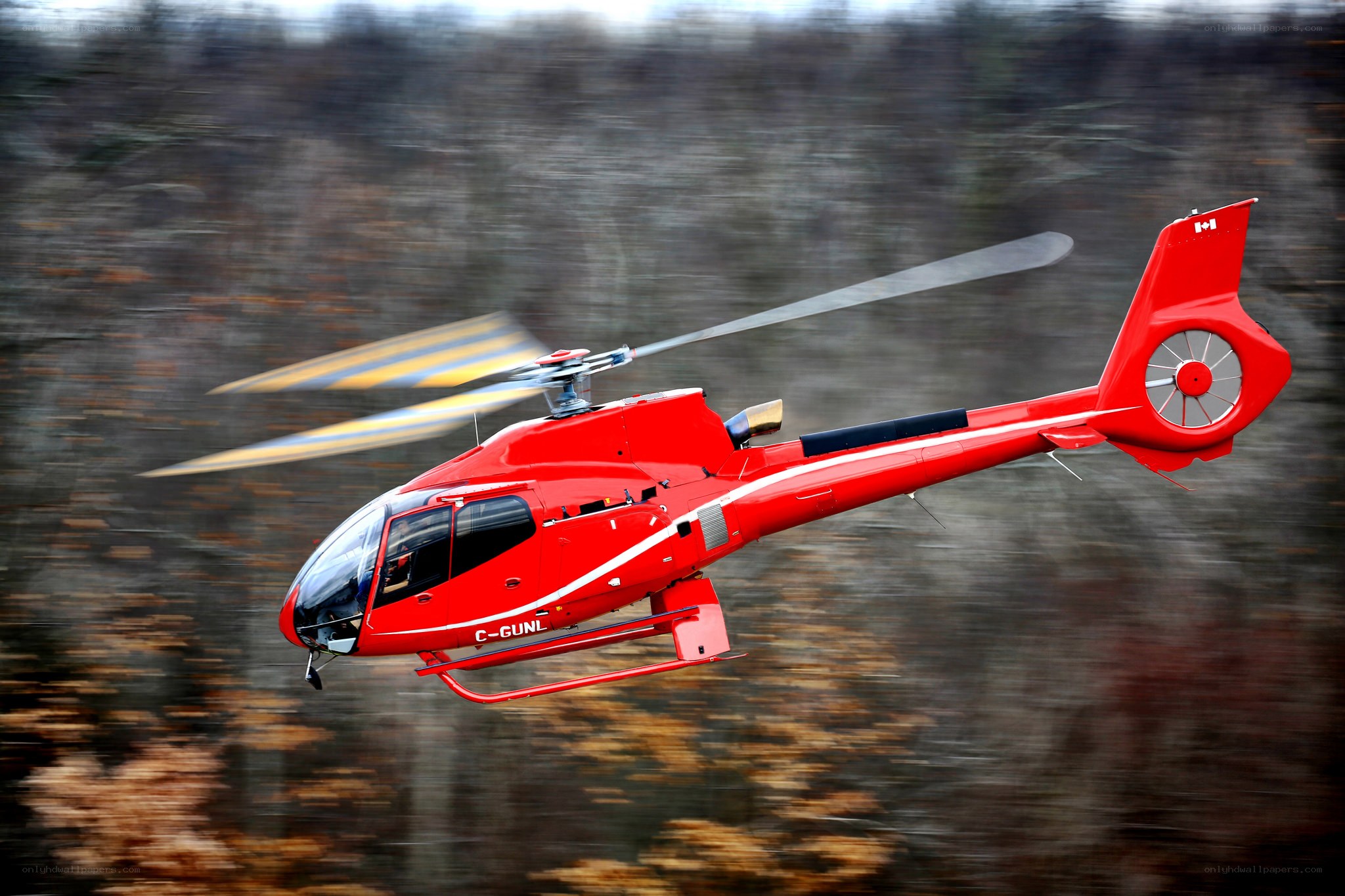 Red helicopter in flight