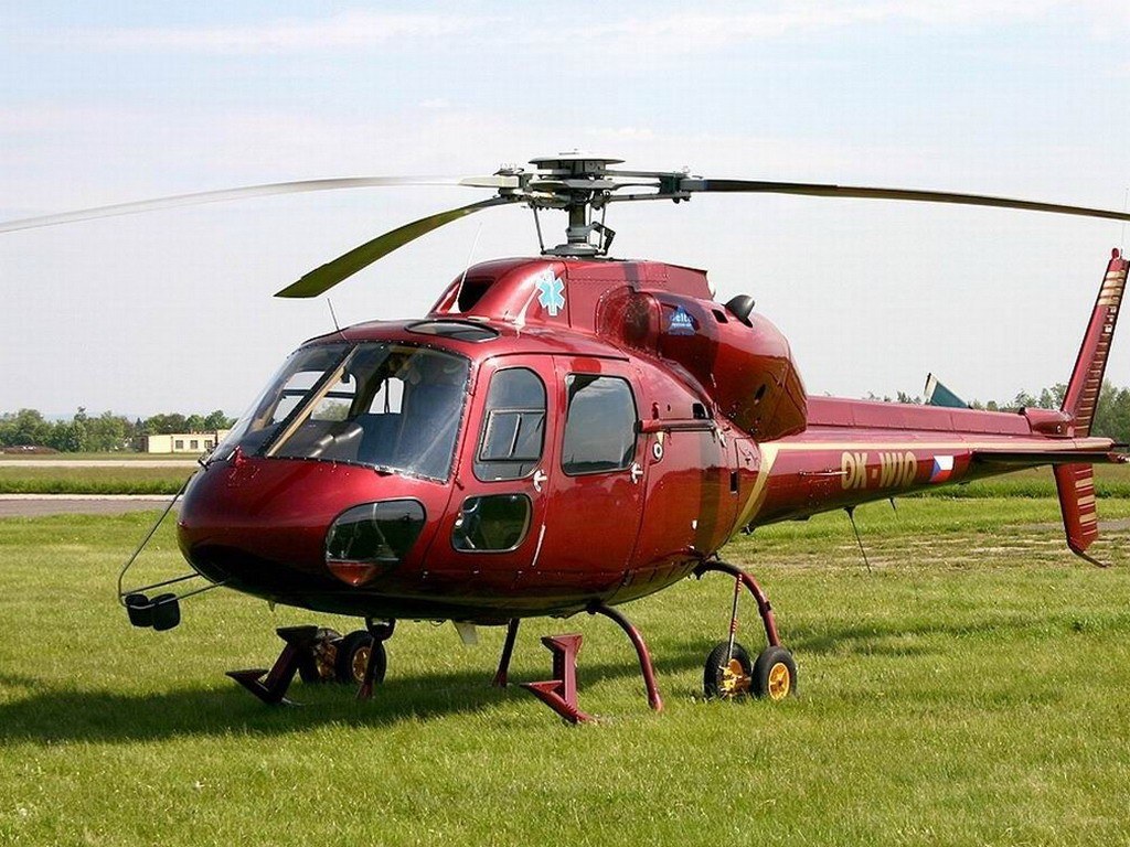 Red helicopter on grass field