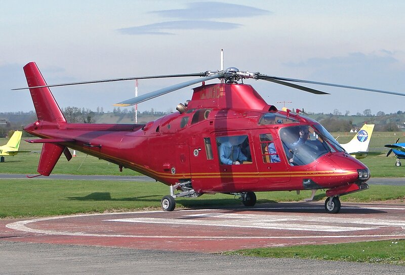 Red helicopter on helipad