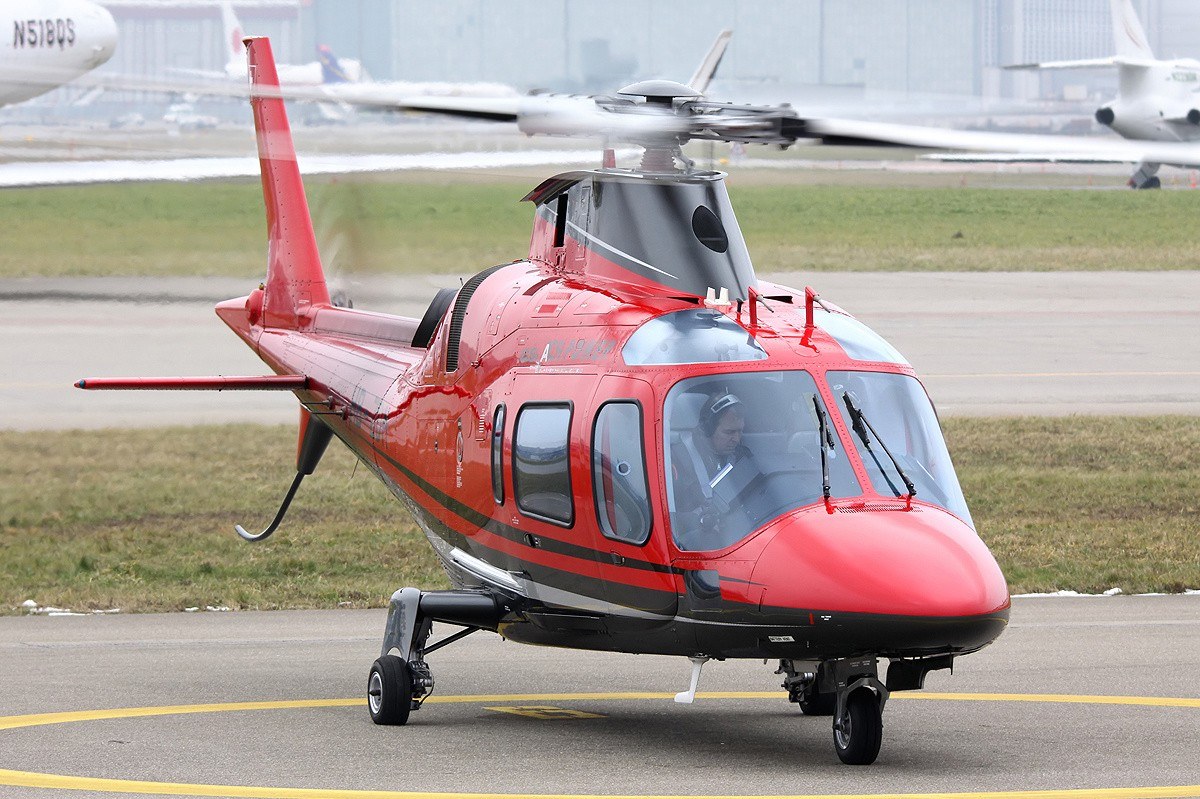 Red helicopter on tarmac