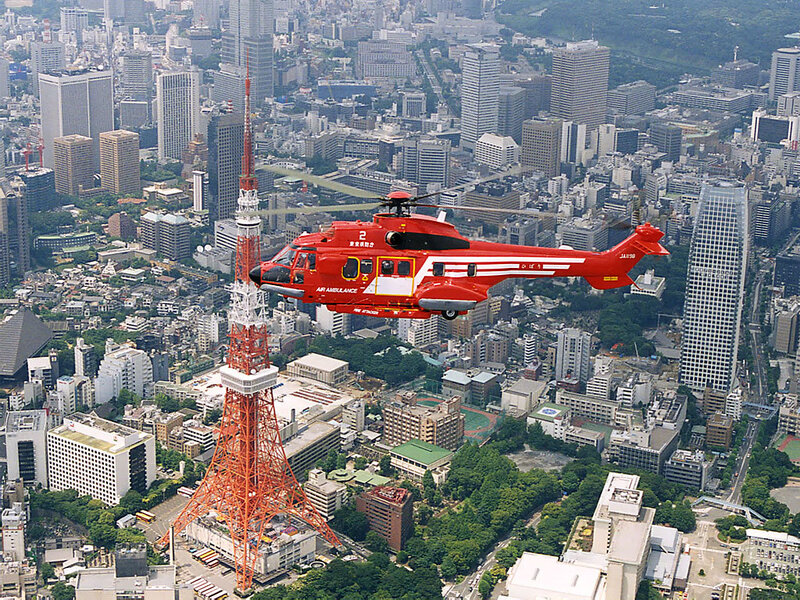 Red helicopter over Tokyo city
