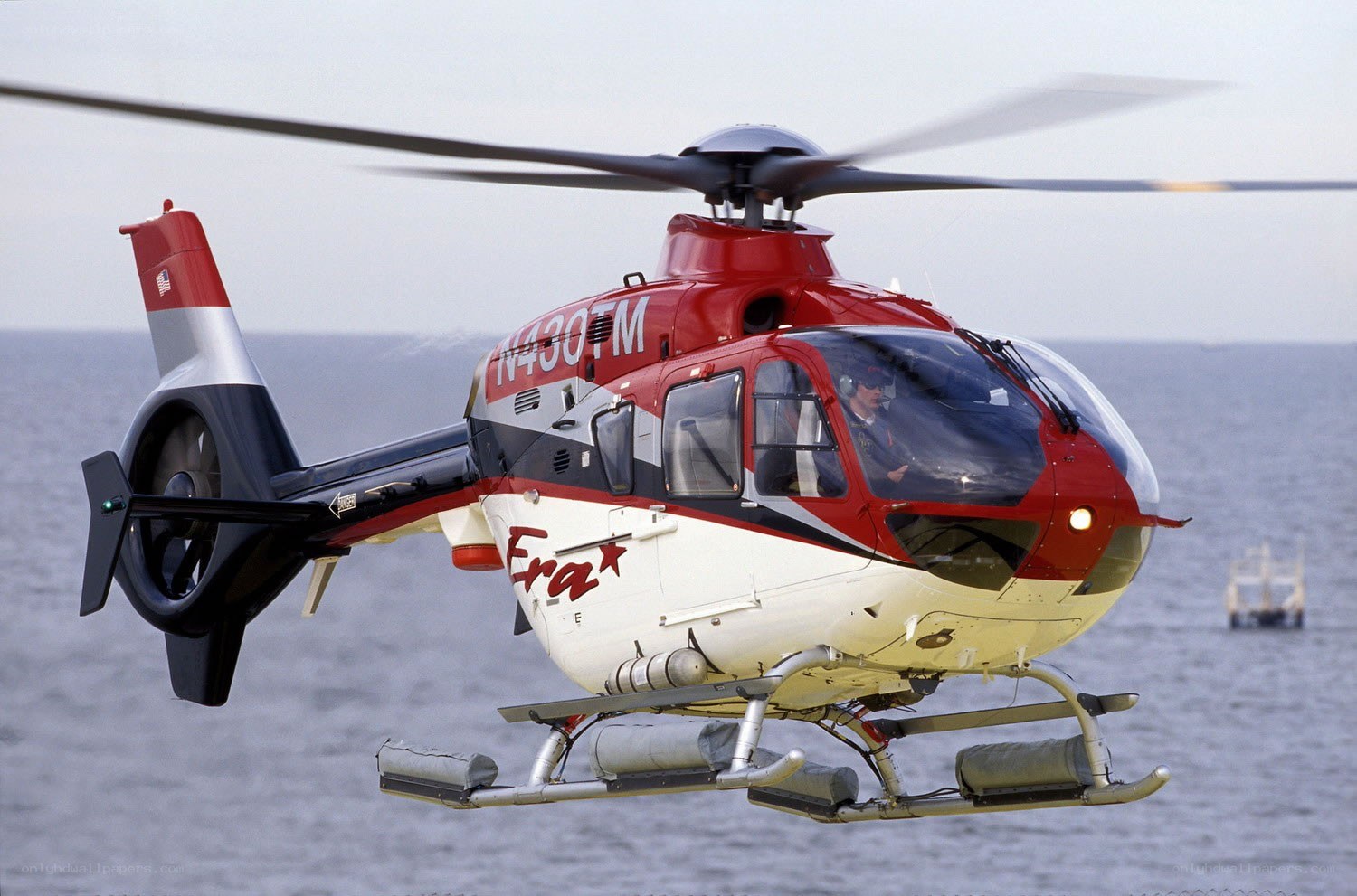 Red helicopter over water