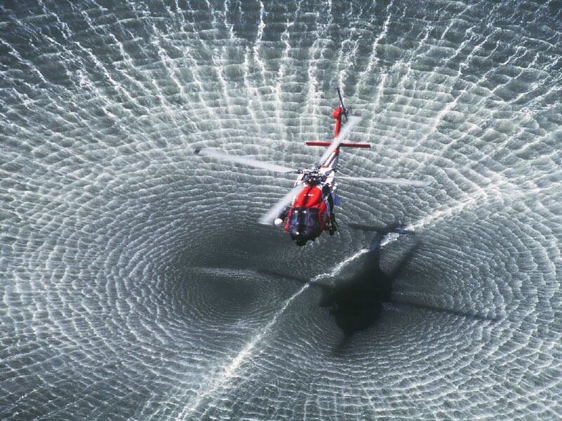 Red Helicopter over Water — Dramatic
