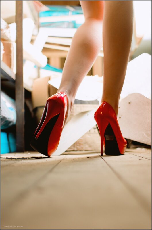 red high heels on wooden floor