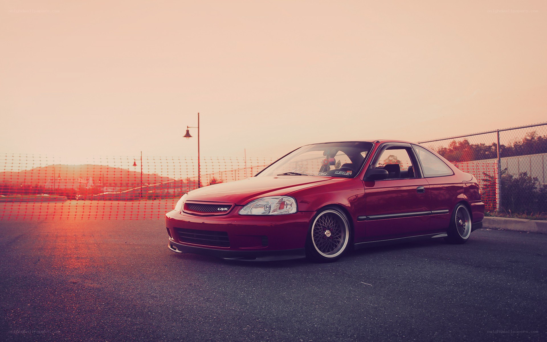 Red Honda Civic at sunset
