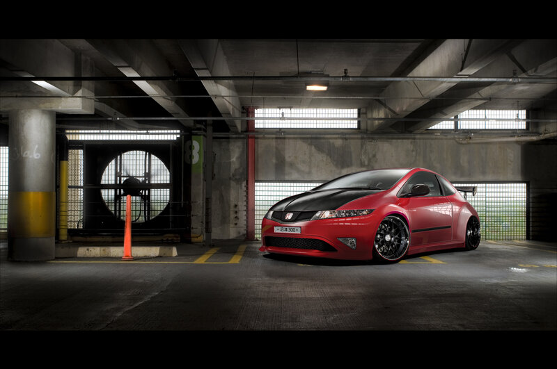 Red Honda Civic in parking garage