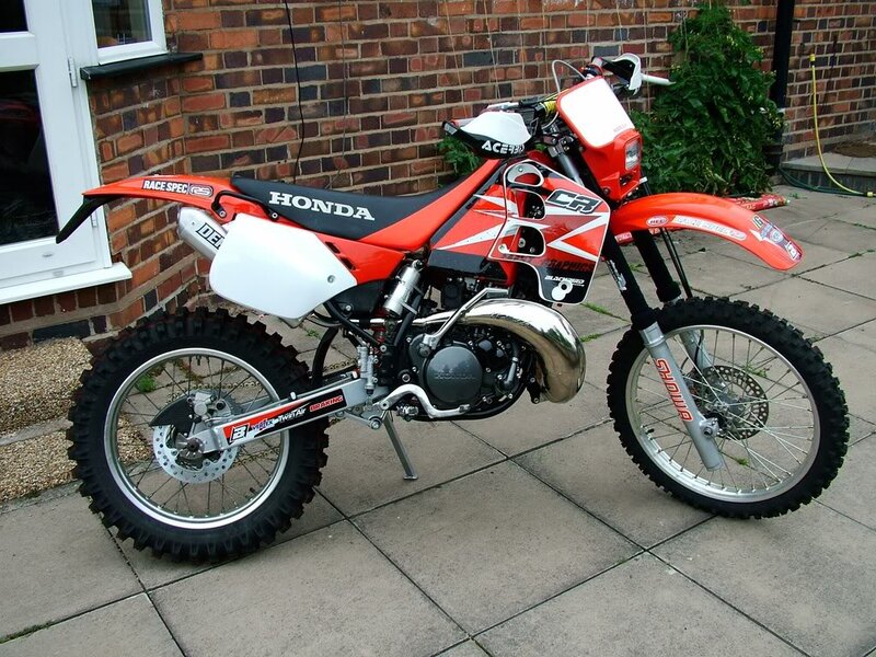 Red Honda Dirt Bike — Neutral, Photograph, Brick Wall