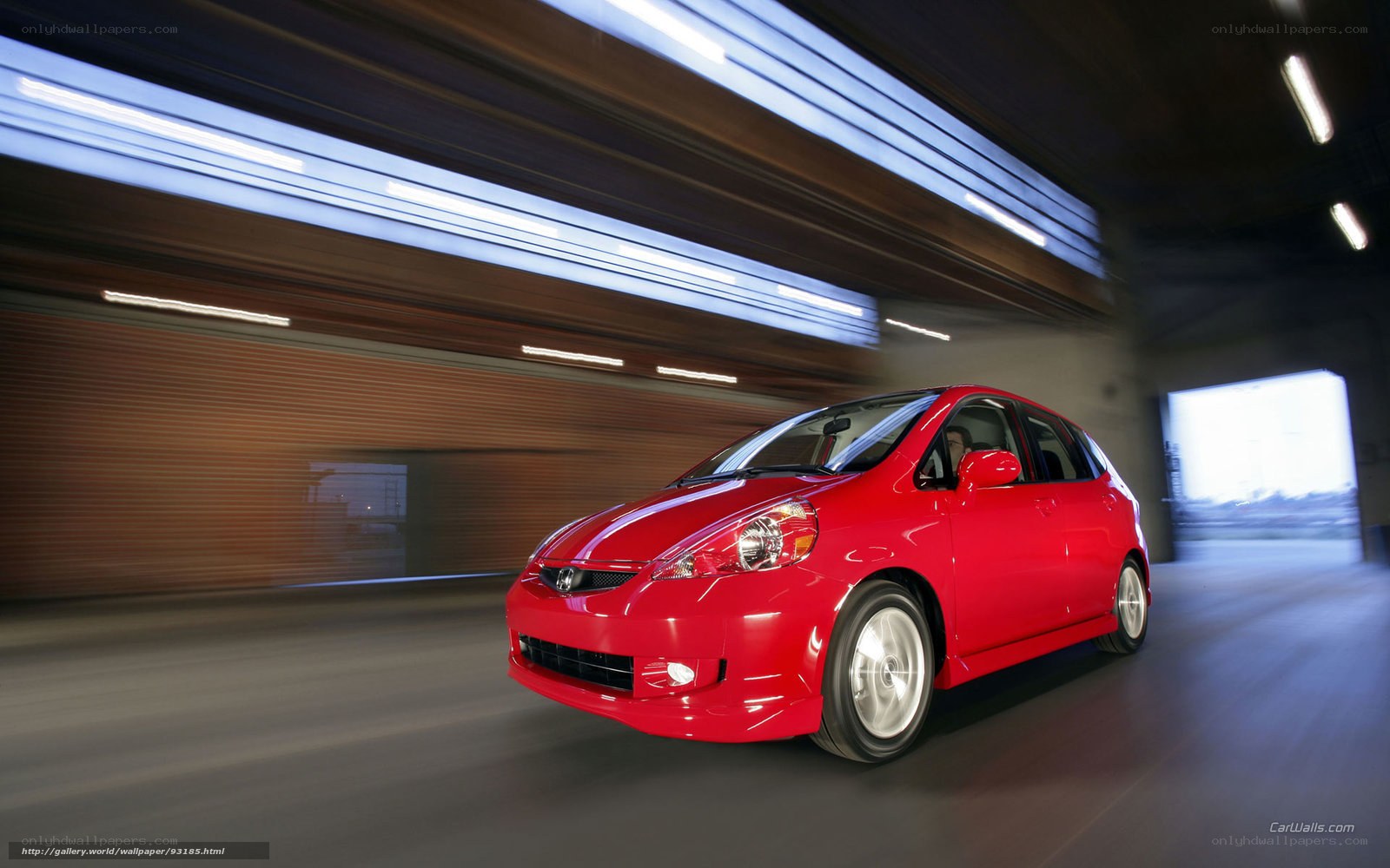 Red Honda Fit in motion
