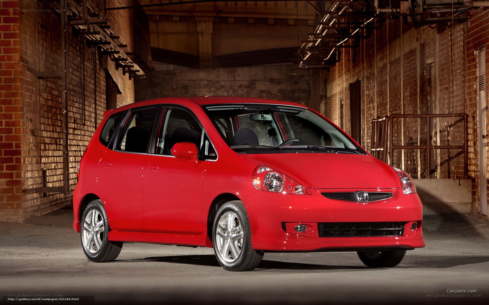 Red Honda Fit in warehouse