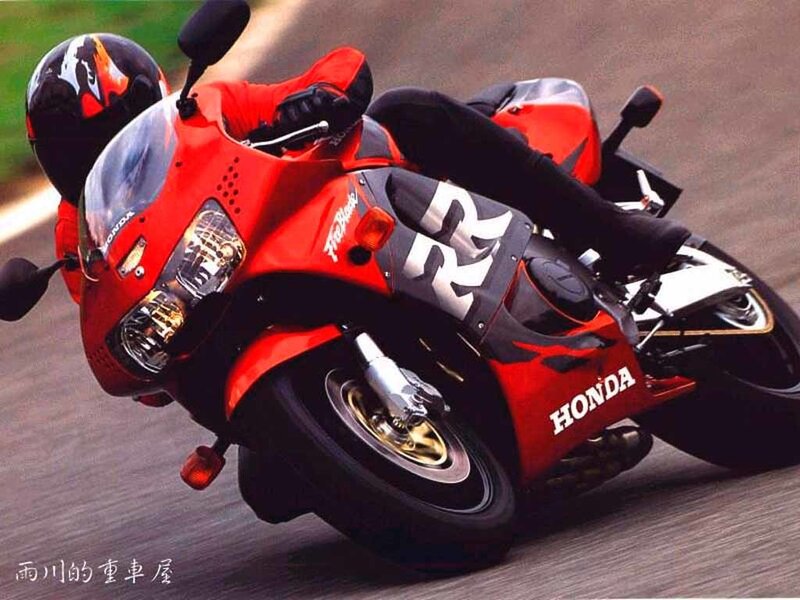 Red Honda motorcycle in motion