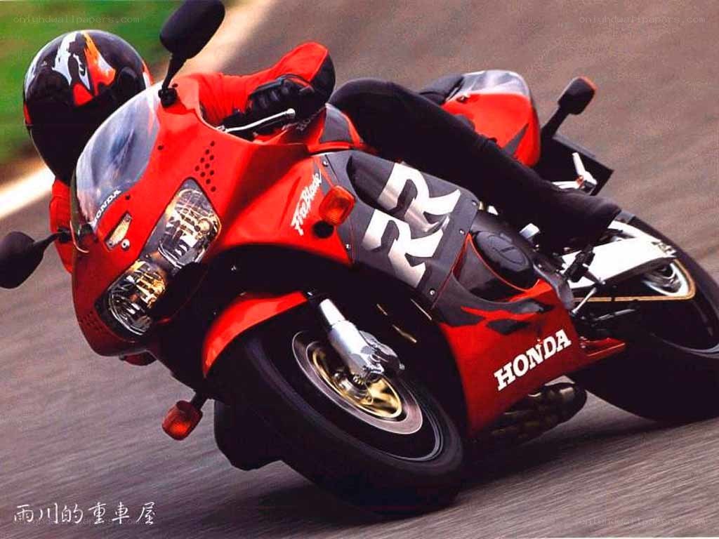 Red Honda motorcycle in motion