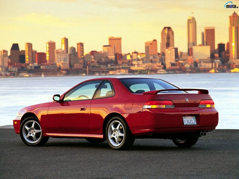 Red Honda Prelude by the city