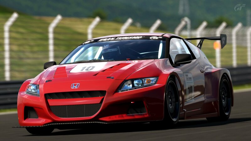 Red Honda race car on track