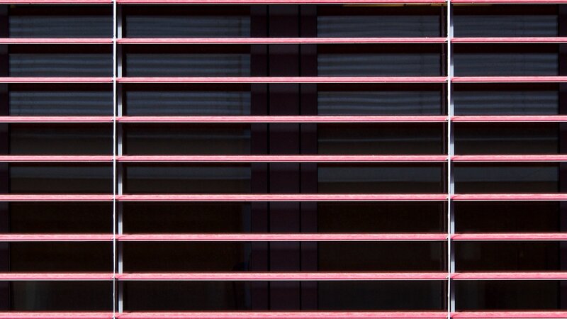 Red horizontal blinds on window