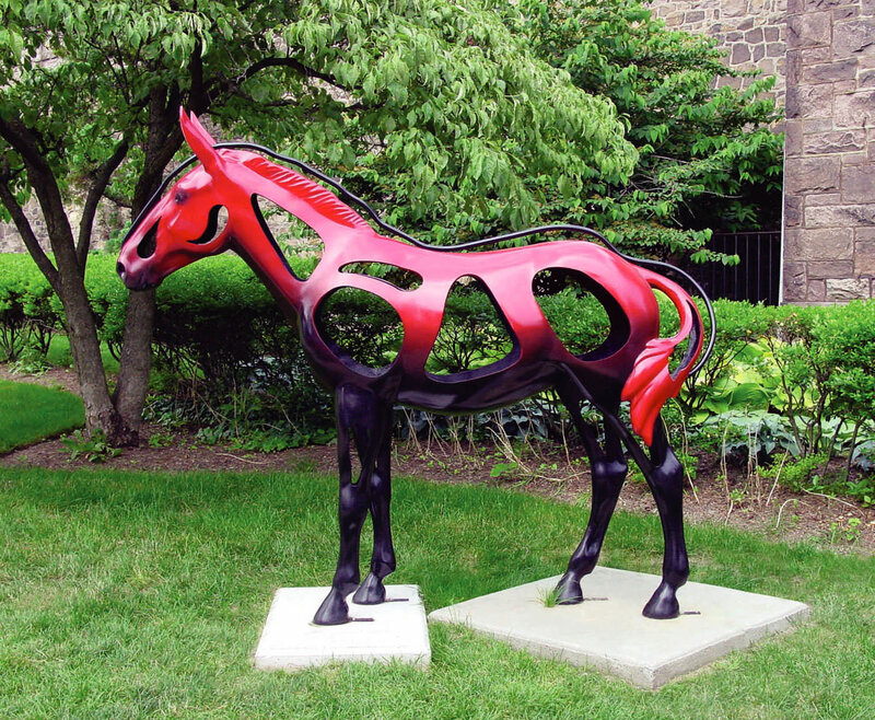 Red horse sculpture in garden