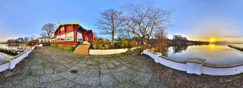 Red house by the lake at sunset