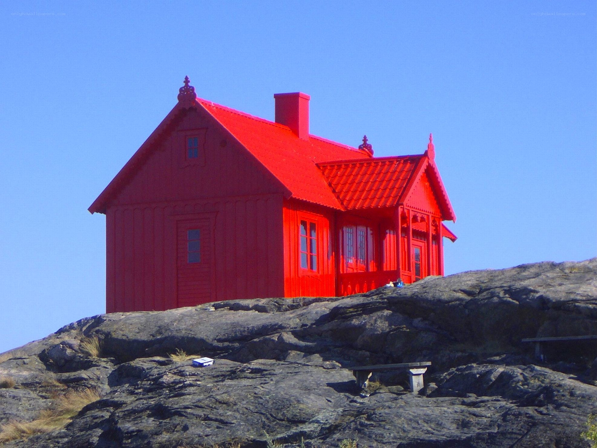 Red house on rocky hill