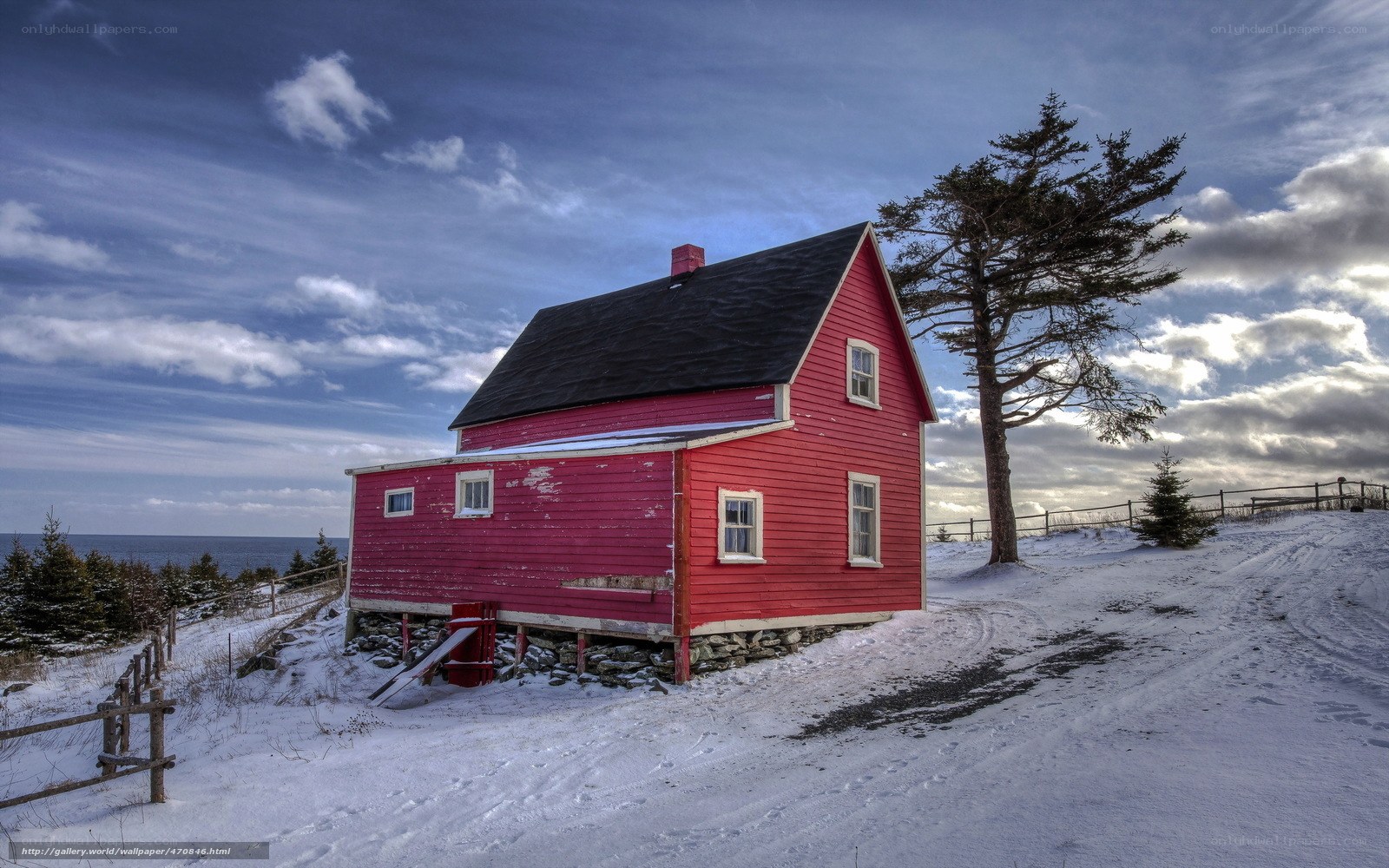 Red house on snowy hill