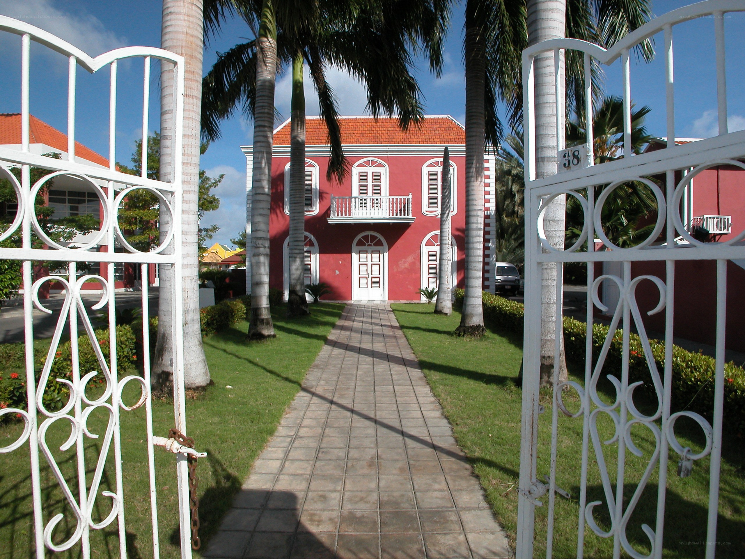 Red house with white gate