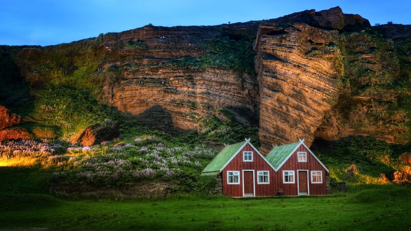 Red houses by a cliff