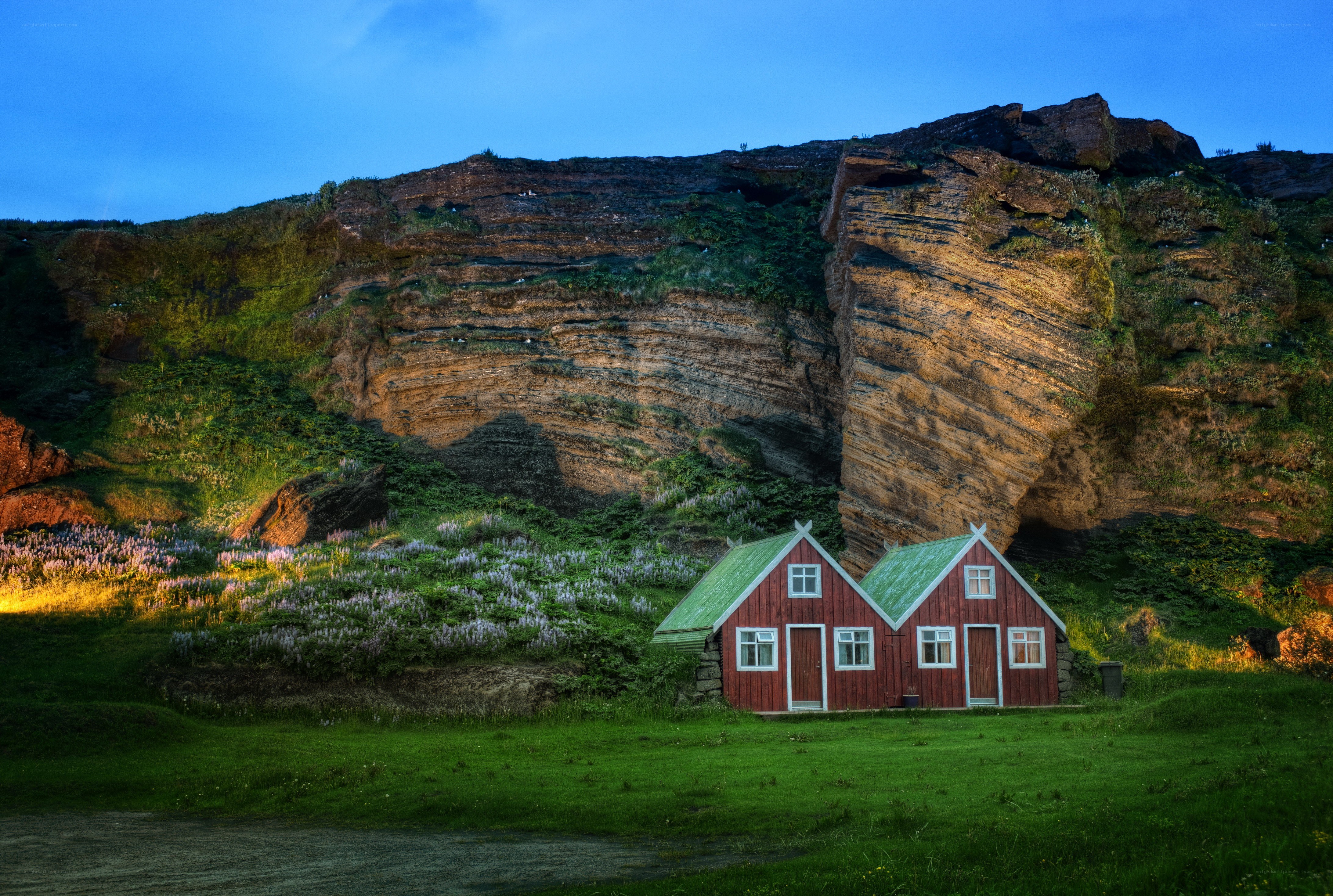 Red houses by a cliff