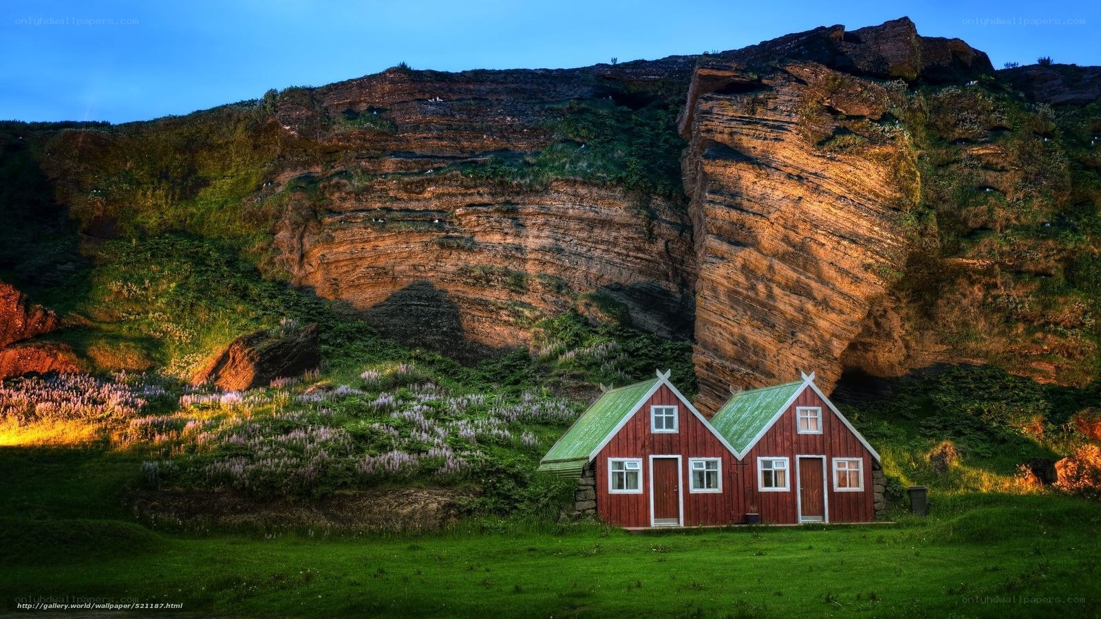 Red houses by a cliff