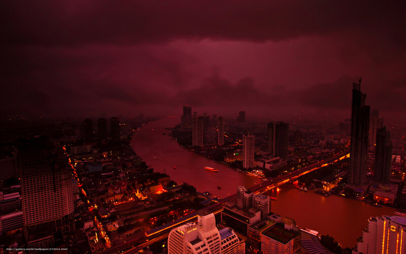 Red-hued cityscape at dusk