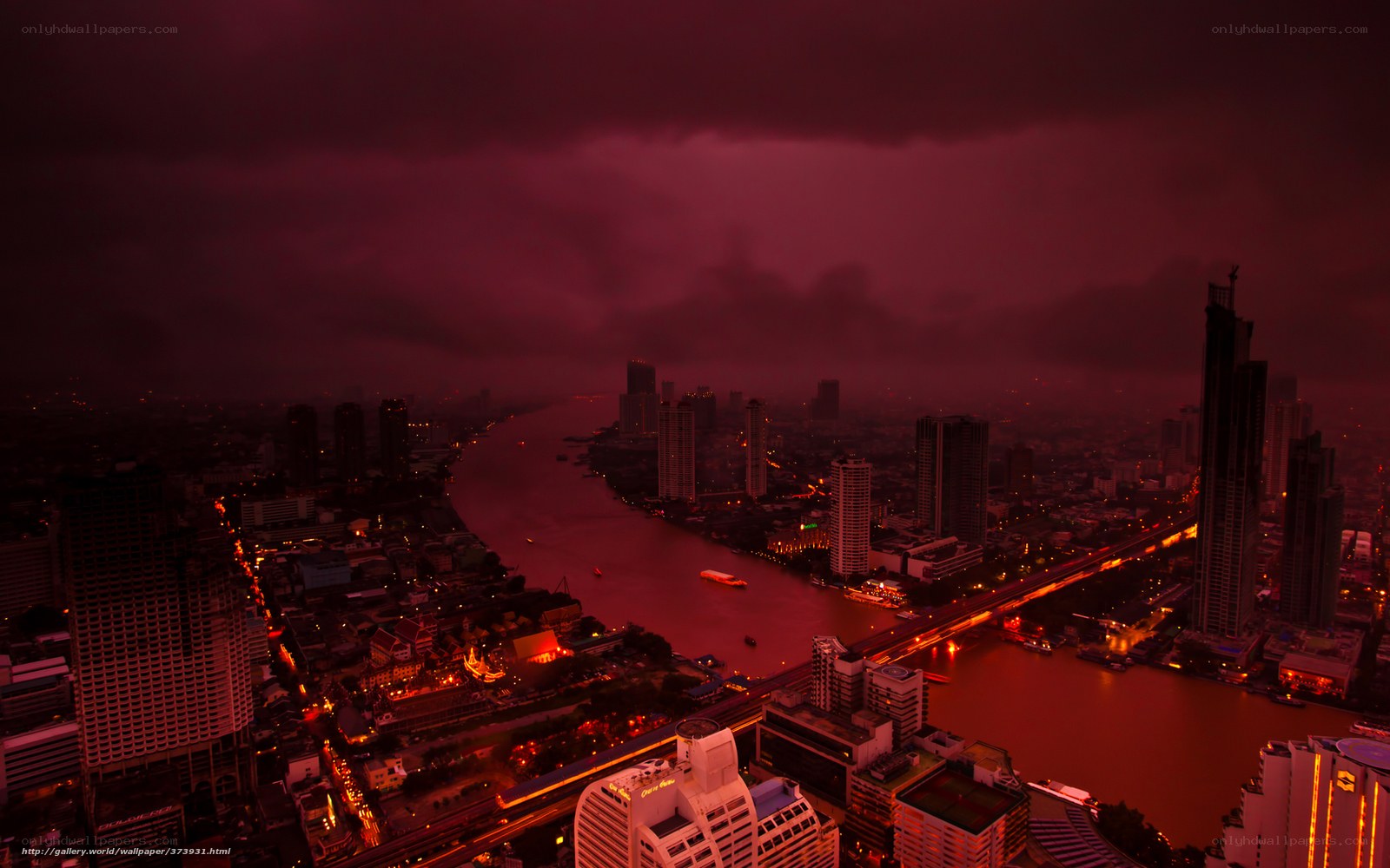 Red-hued cityscape at dusk