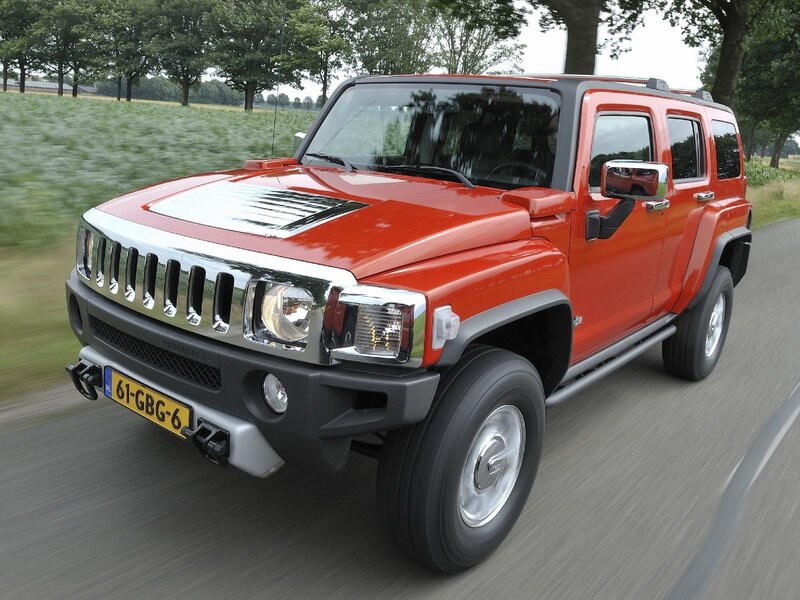 Red Hummer H3 on a country road