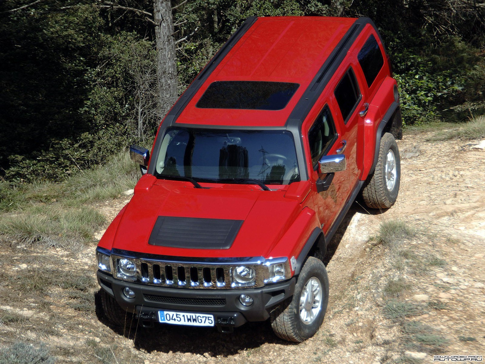 Red Hummer H3 on a dirt path
