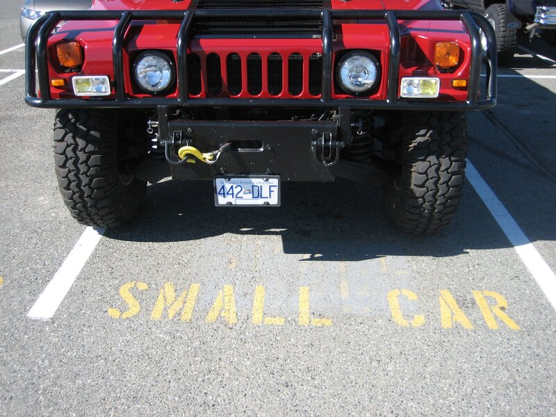Red Hummer in small car spot