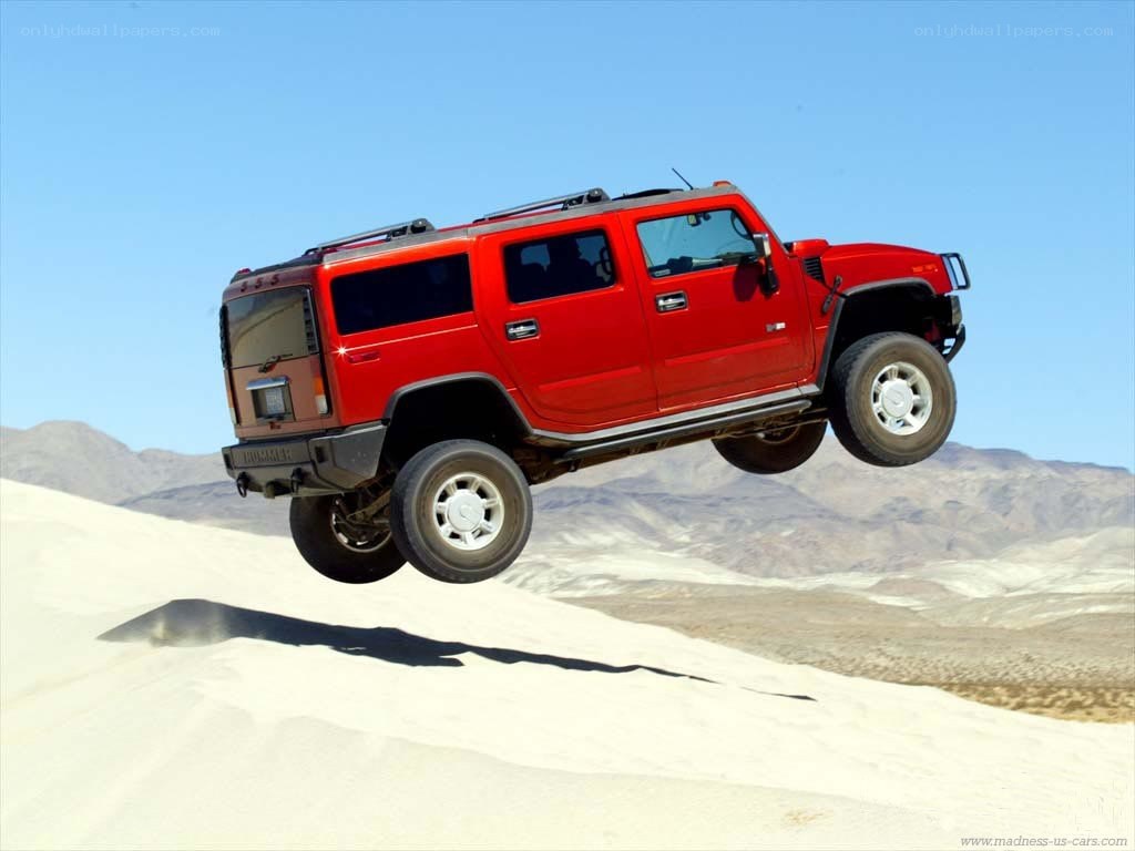 red hummer jumping in desert