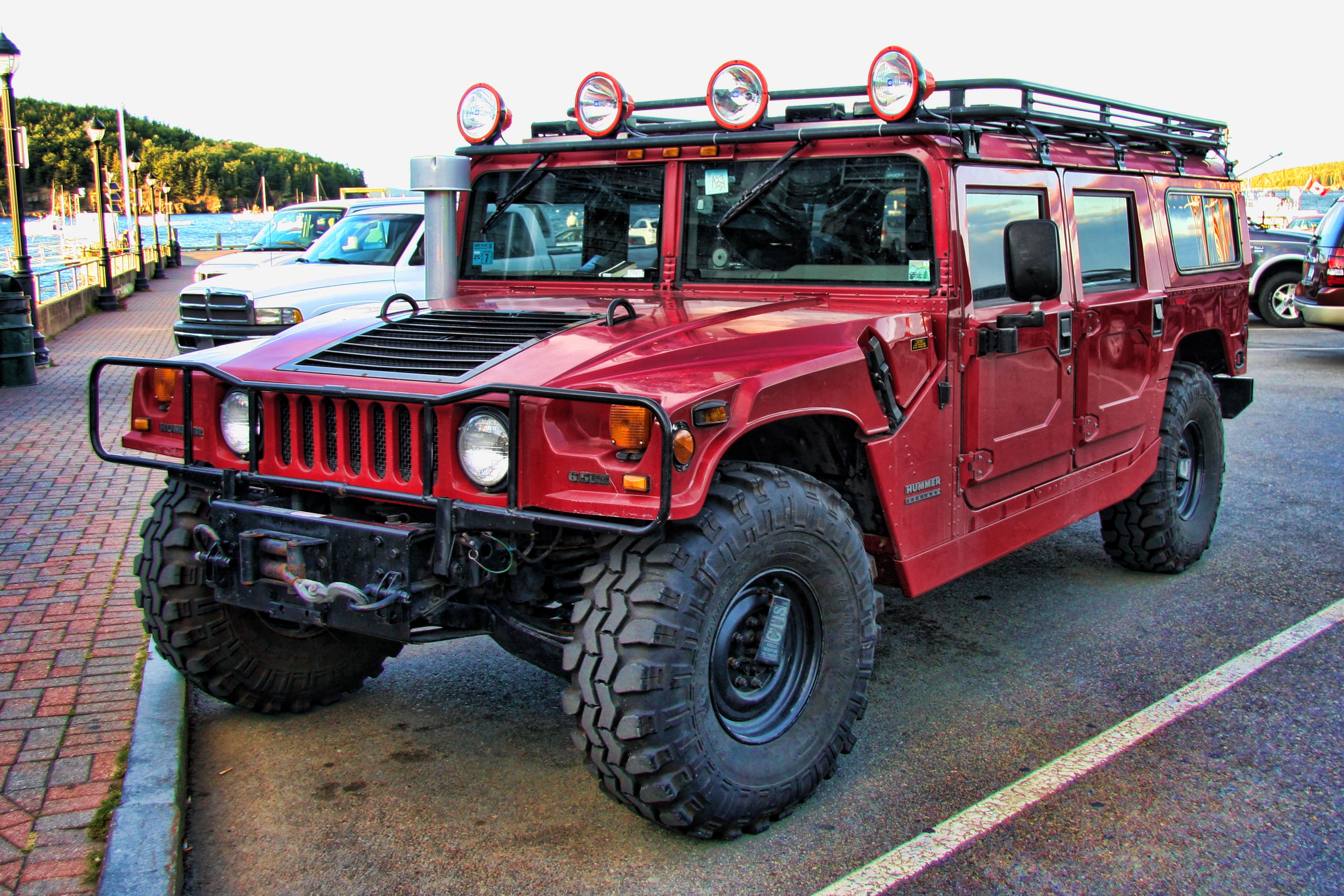 Red Hummer parked by the water