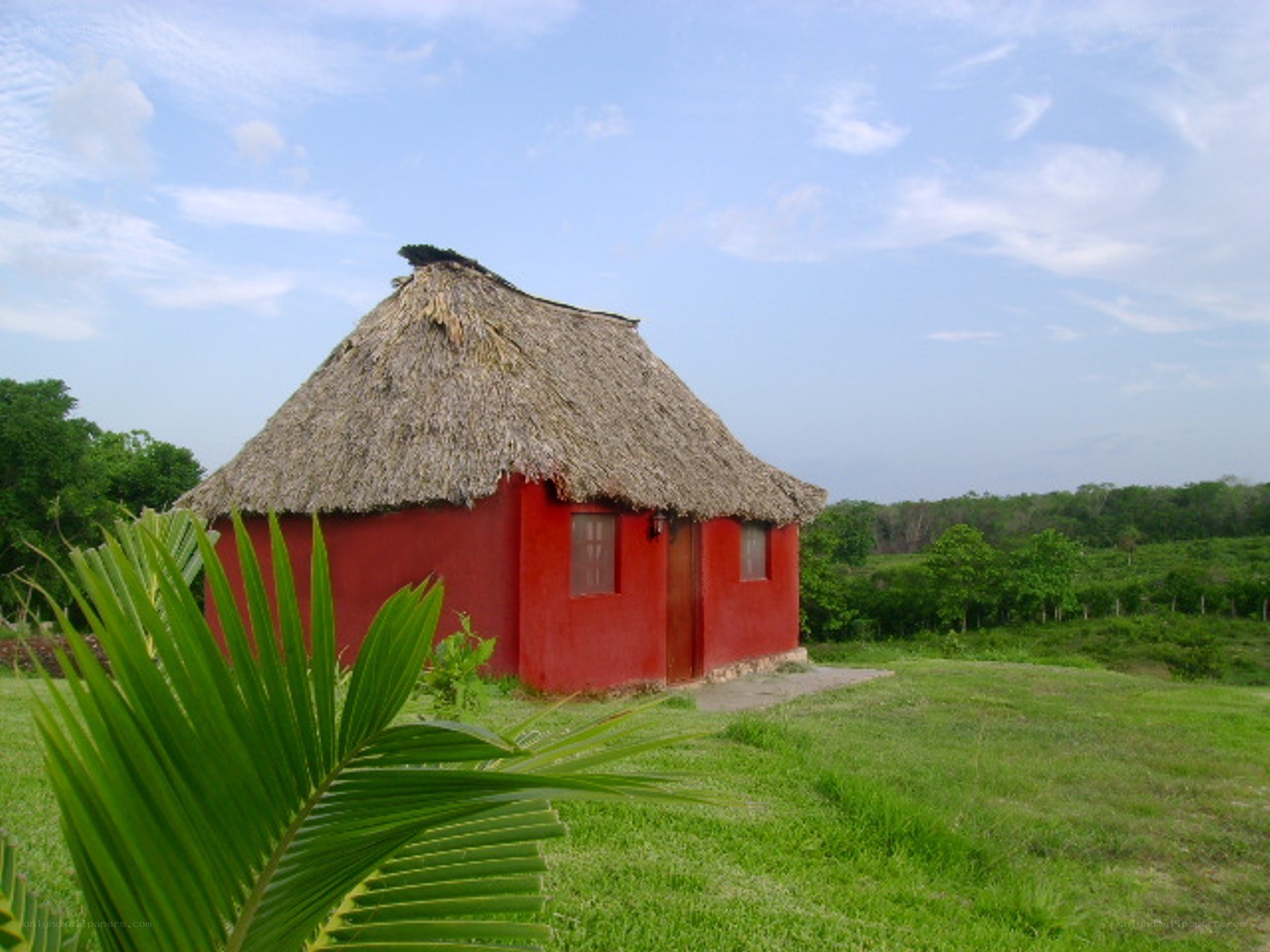 Red hut with thatched roof