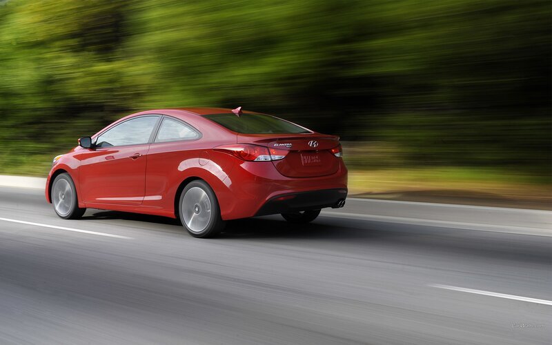 red hyundai elantra in motion