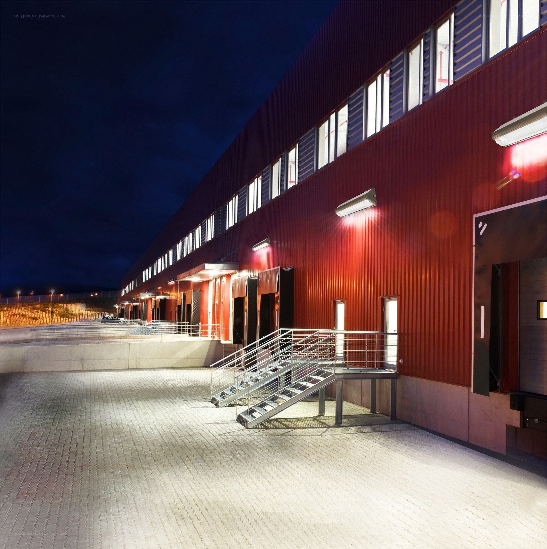 Red industrial building at night