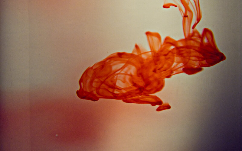 Red ink dispersing in water