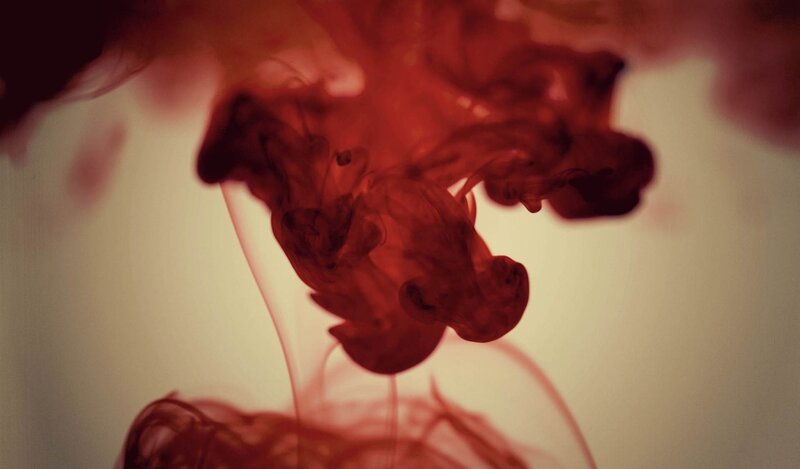 red ink dispersing in water