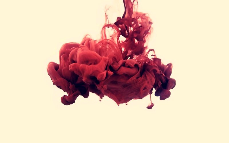 red ink dispersing in water