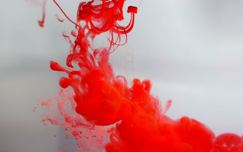 Red ink dispersing in water