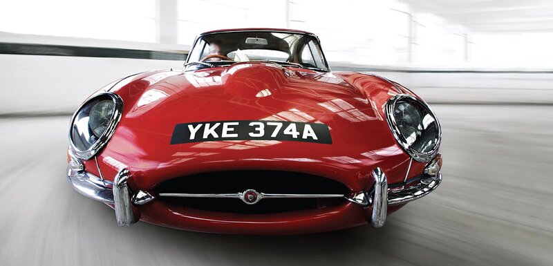 Red Jaguar E-Type in motion