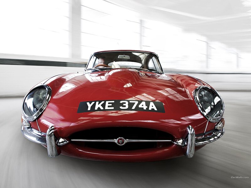 Red Jaguar E-Type in motion
